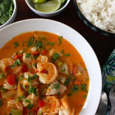  Moqueca de Peixe: A Creamy Seafood Stew Infused with Aromatic Herbs and Hints of Coconut Milk!